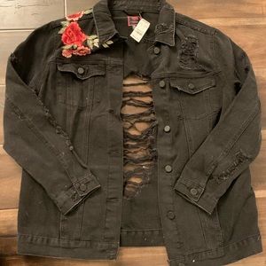 A black ripped jean jacket with a rose pattern